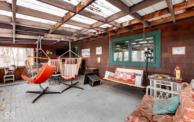 interior space with concrete block wall and wood finished floors