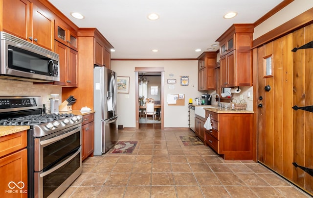 kitchen with glass insert cabinets, appliances with stainless steel finishes, brown cabinetry, and backsplash