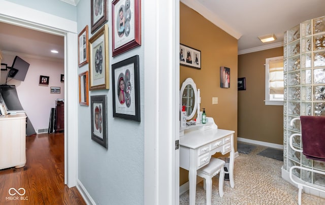 corridor featuring dark wood-style floors, baseboards, and crown molding