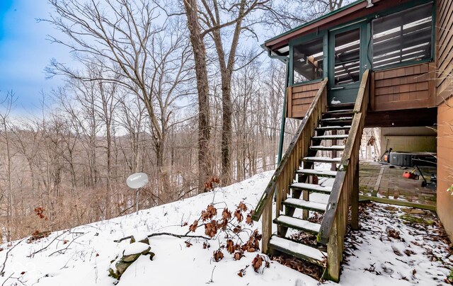 yard layered in snow featuring stairs