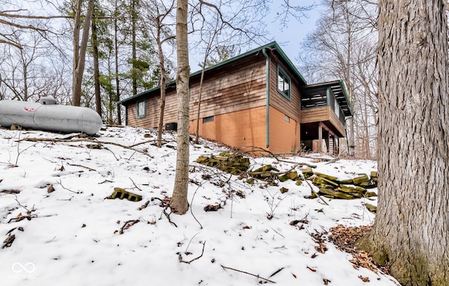 snow covered property featuring a garage