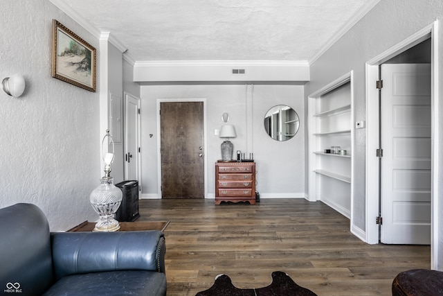 living area featuring visible vents, dark wood-type flooring, ornamental molding, a textured ceiling, and baseboards