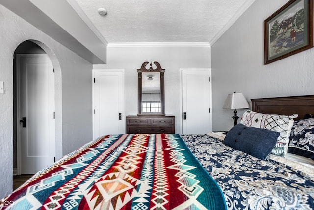 bedroom featuring a textured ceiling, arched walkways, and crown molding