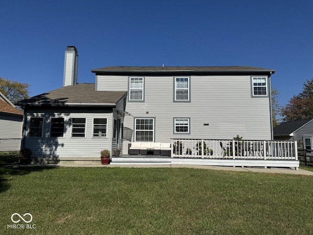 rear view of property with outdoor lounge area, a yard, and a deck