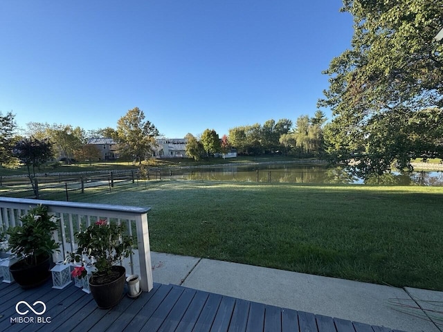 view of yard with a deck with water view