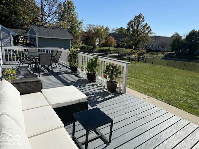 wooden terrace featuring an outdoor hangout area and a lawn