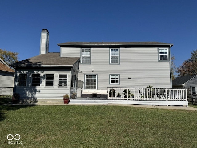 back of house with a wooden deck, an outdoor hangout area, and a lawn