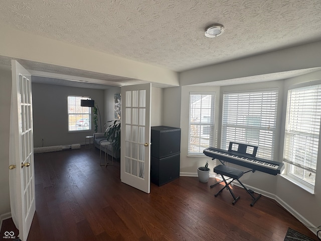 office with french doors, dark hardwood / wood-style floors, and a textured ceiling