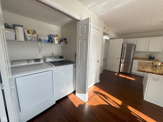 laundry area featuring washer and clothes dryer, dark hardwood / wood-style floors, and a textured ceiling