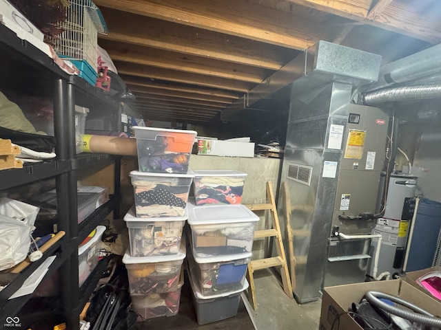 storage room with heating unit and electric water heater