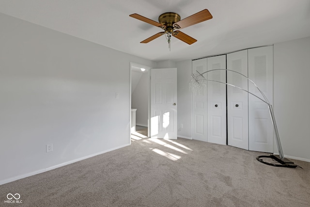 unfurnished bedroom with carpet floors, ceiling fan, and a closet