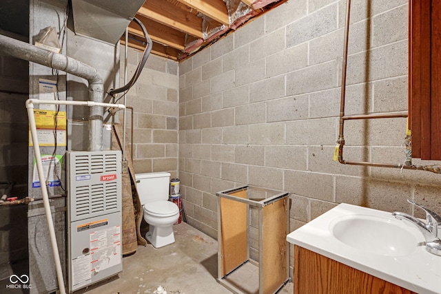 bathroom with toilet, vanity, and concrete flooring