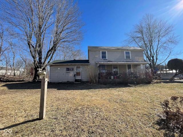 view of front of house with a porch and a front yard