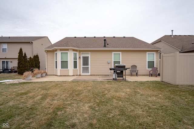 rear view of house featuring a yard, a patio, and fence