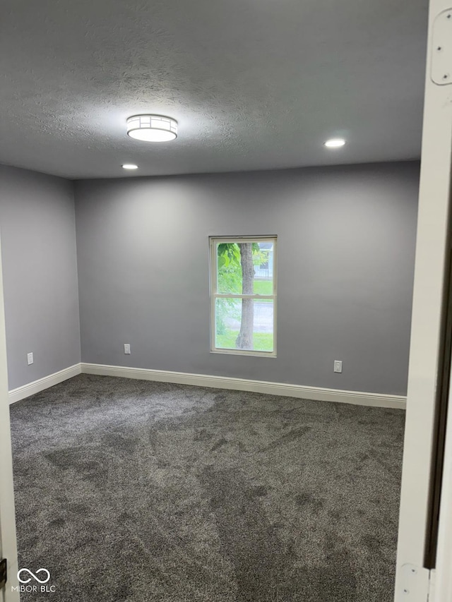 2312 Fletcher St, Anderson, IN 46016 - carpeted spare room featuring baseboards, a textured ceiling, and recessed lighting