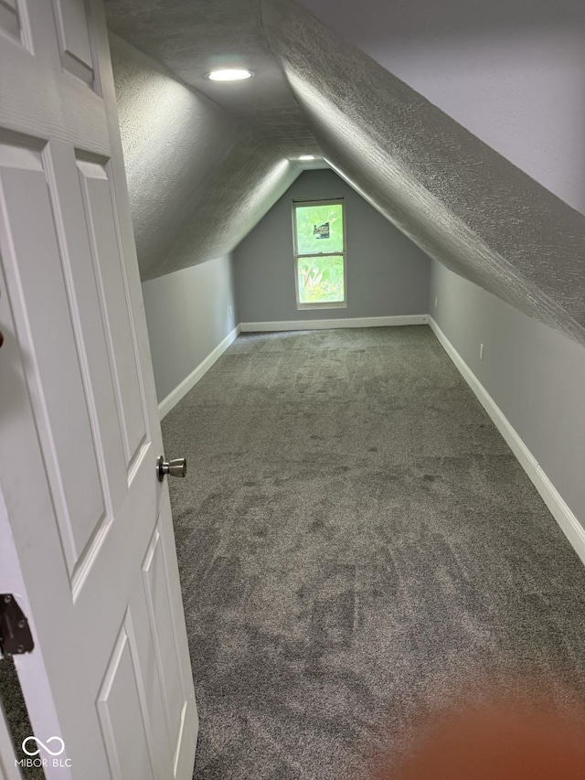 2312 Fletcher St, Anderson, IN 46016 - bonus room with a textured ceiling, carpet, vaulted ceiling, and baseboards