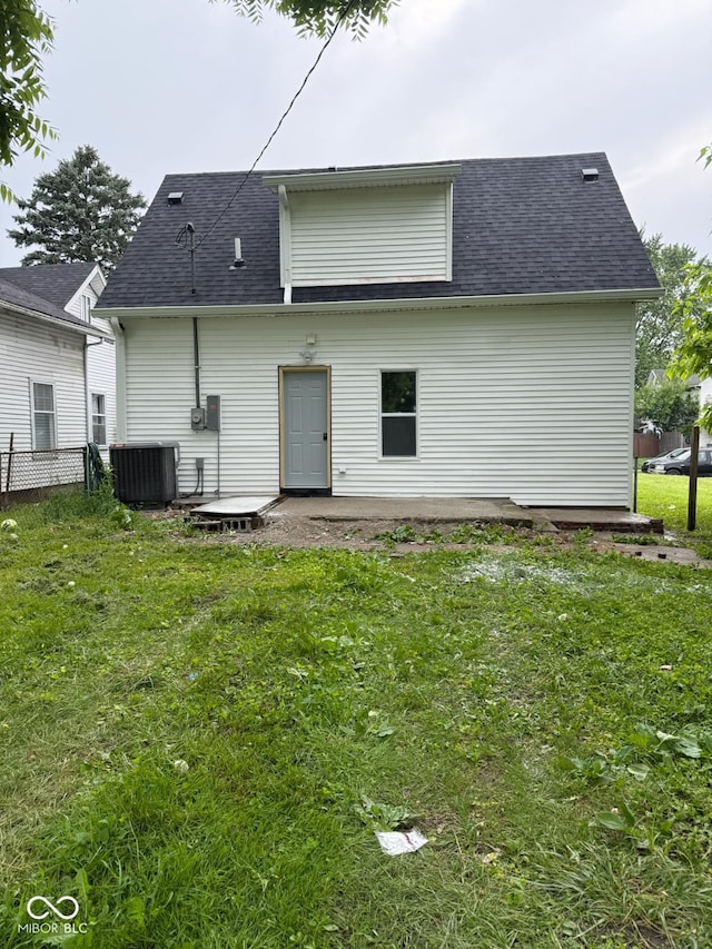 2312 Fletcher St, Anderson, IN 46016 - back of house with central AC, a shingled roof, and a patio