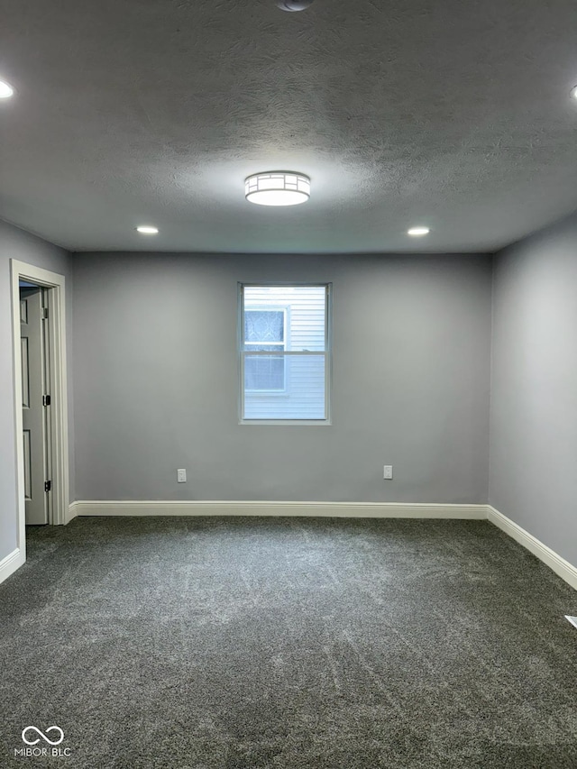 2312 Fletcher St, Anderson, IN 46016 - empty room featuring dark colored carpet, baseboards, recessed lighting, and a textured ceiling
