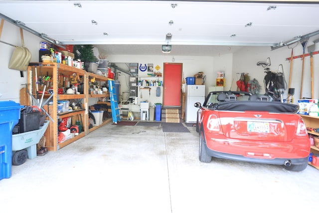 garage with a garage door opener and freestanding refrigerator