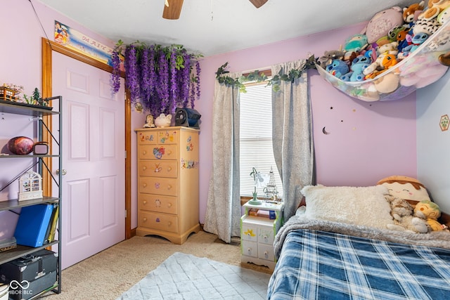 bedroom featuring light carpet and a ceiling fan