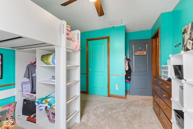 bedroom featuring light carpet and a ceiling fan
