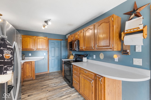 kitchen featuring light countertops, appliances with stainless steel finishes, and brown cabinets