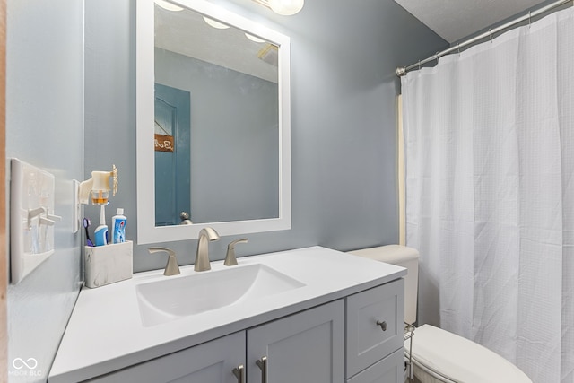 full bathroom with toilet, curtained shower, and vanity