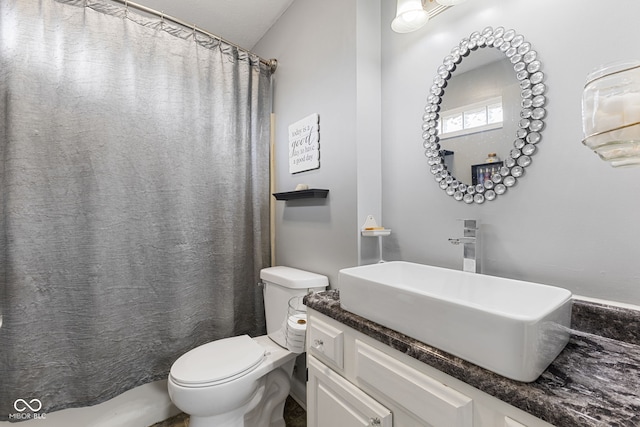 full bathroom with toilet, a shower with shower curtain, and vanity