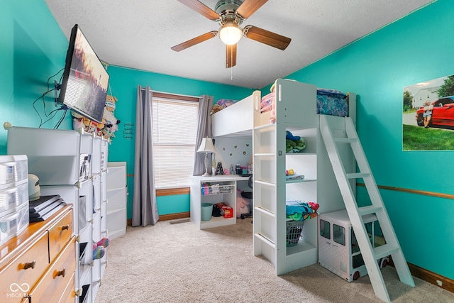 bedroom with a ceiling fan, a textured ceiling, and light colored carpet