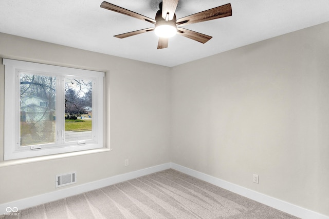 carpeted empty room featuring ceiling fan