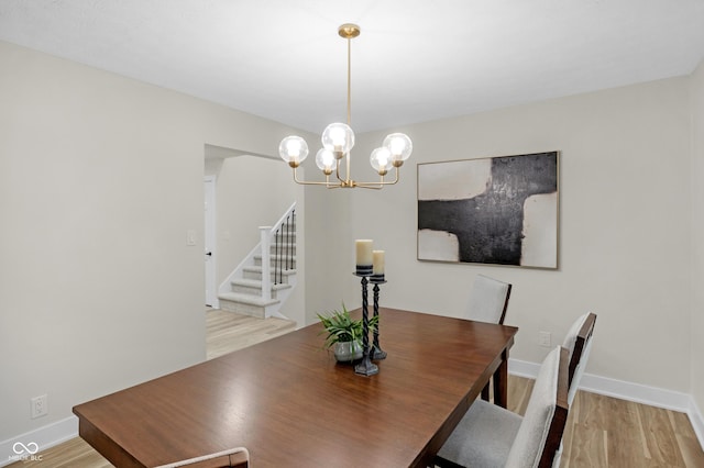 dining space featuring a notable chandelier and light hardwood / wood-style flooring