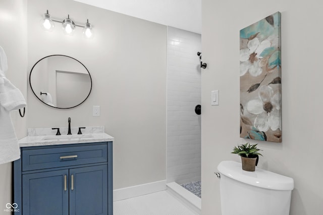 bathroom featuring tiled shower, vanity, toilet, and tile patterned floors