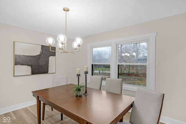 dining space with a notable chandelier and light wood-type flooring