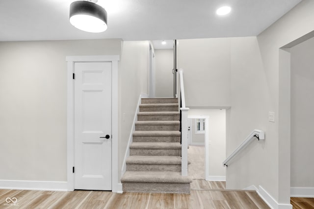 stairway featuring wood-type flooring