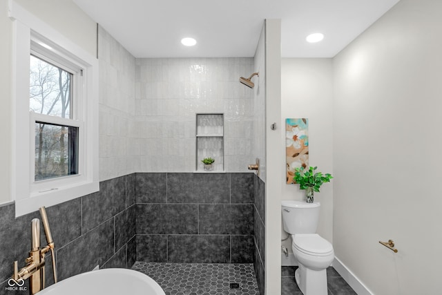 bathroom featuring toilet and a tile shower