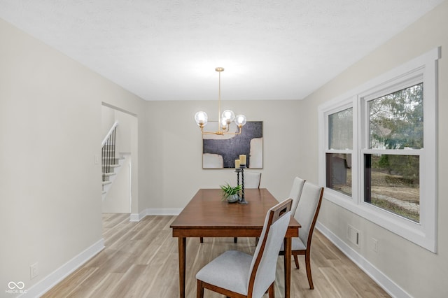 dining area featuring a chandelier and light hardwood / wood-style flooring