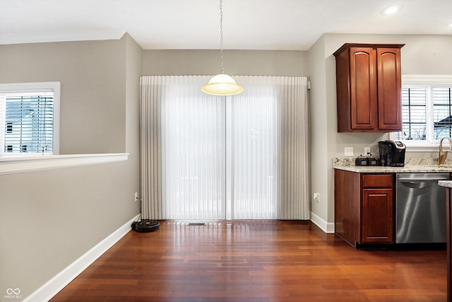 kitchen featuring dishwasher, dark wood-type flooring, and decorative light fixtures