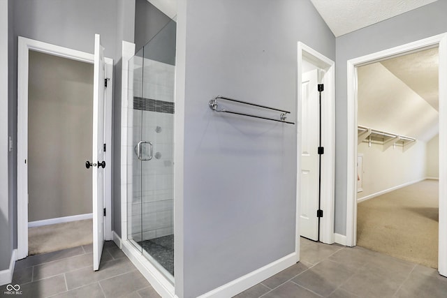 bathroom with tile patterned flooring and an enclosed shower