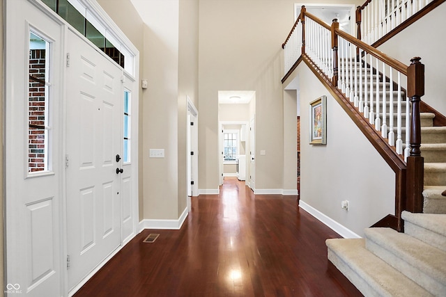 foyer featuring a high ceiling and dark hardwood / wood-style floors