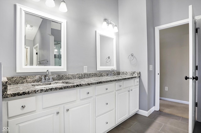 bathroom with tile patterned floors and vanity