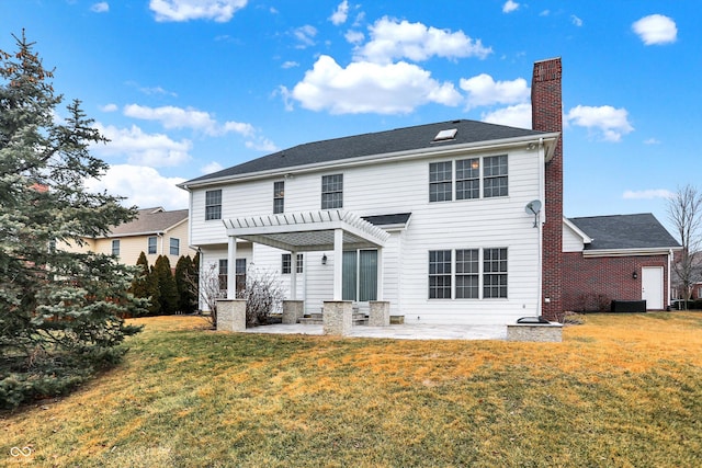 back of house with a yard, a pergola, and a patio area