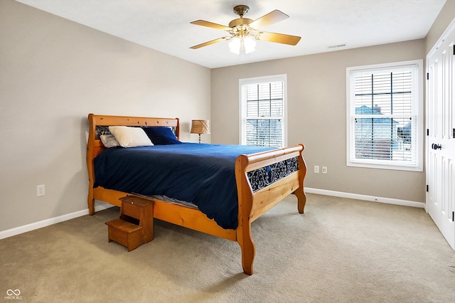 bedroom with light carpet and ceiling fan