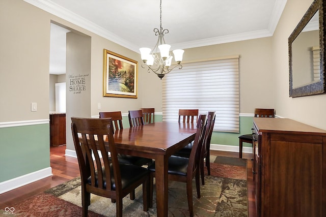 dining room with a notable chandelier, ornamental molding, and dark hardwood / wood-style floors