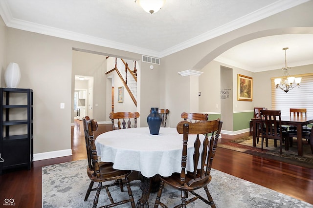 dining space with crown molding, dark hardwood / wood-style flooring, and a chandelier