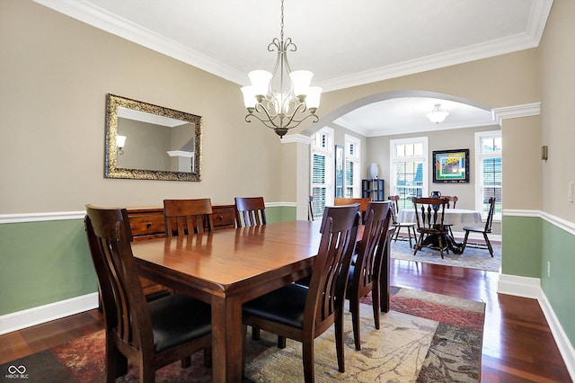 dining area featuring a notable chandelier, crown molding, and dark wood-type flooring