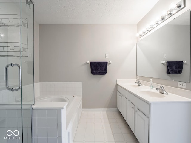 full bath with a textured ceiling, a sink, and a shower stall