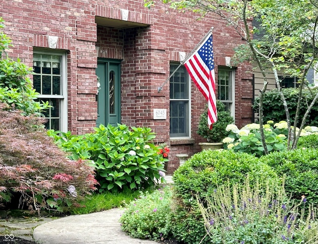 view of exterior entry with brick siding