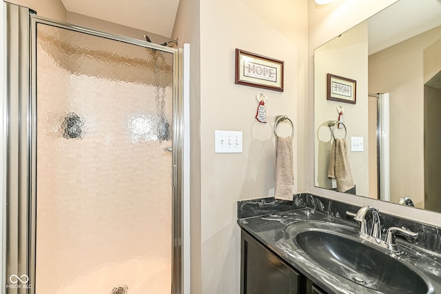 bathroom featuring a stall shower and vanity