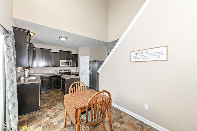 dining area featuring stone finish flooring and baseboards