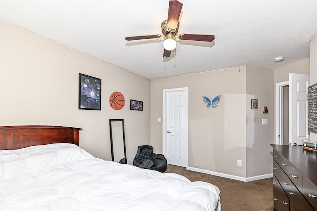 bedroom with a ceiling fan, dark carpet, a textured ceiling, and baseboards